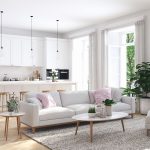 Otvorený priestor obývačky a kuchyne v bielej farbe a modernom škandinávskom štýle