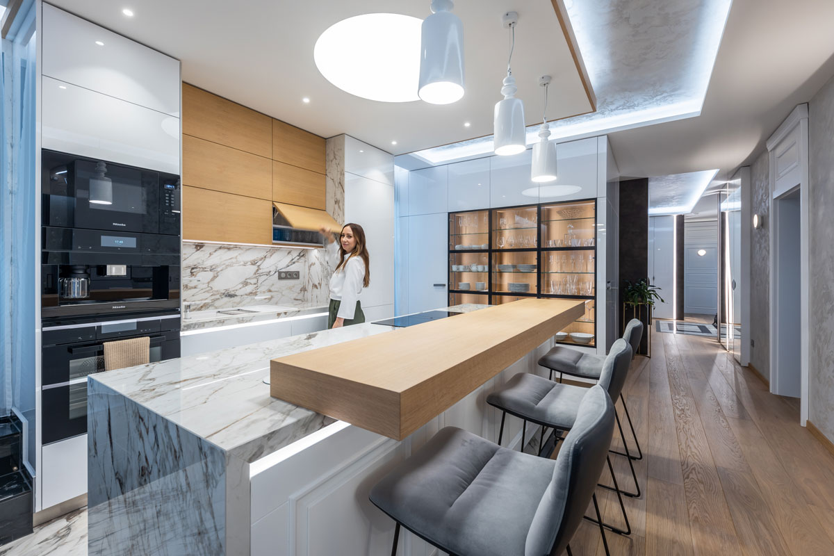 moderná luxusná kuchyňa s mramorovým ostrovčekom, so skrytou špajzou, presklenou vitrínou na riady a zabudovanými spotrebičmi